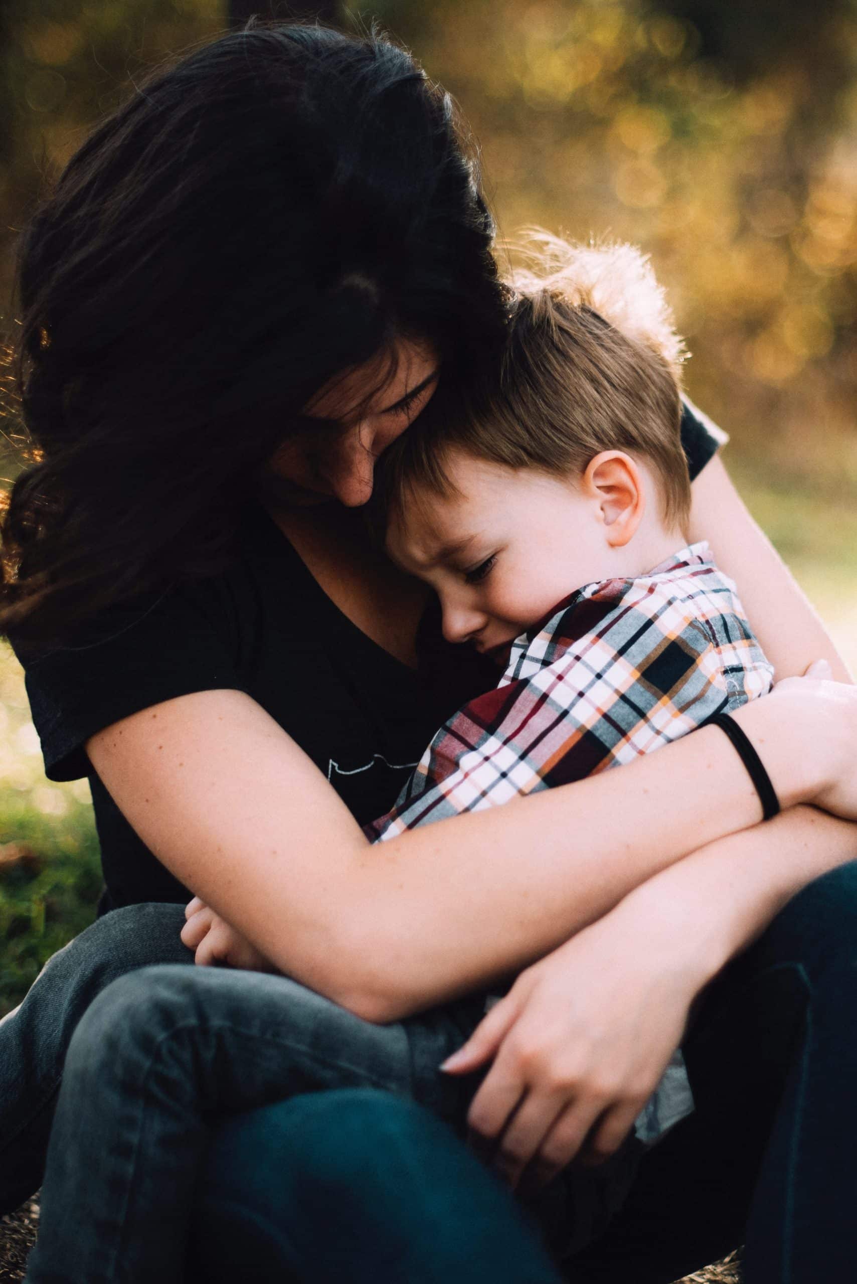 A mom hugs her son. A tight hug can really help a child who is feeling anxious or having a panic attack.